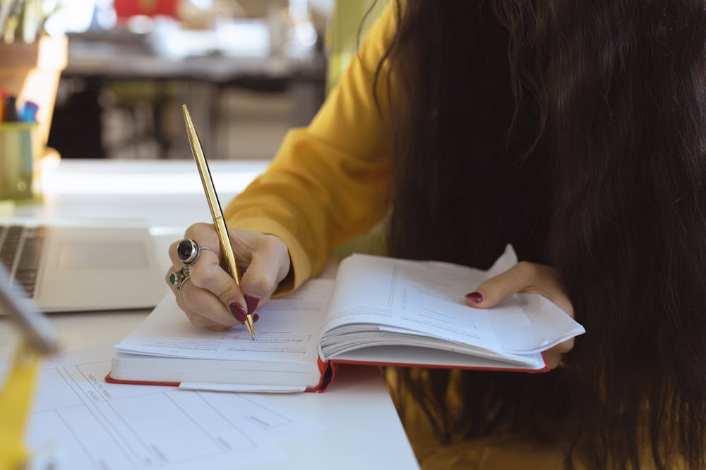 Woman writing in her planner.
